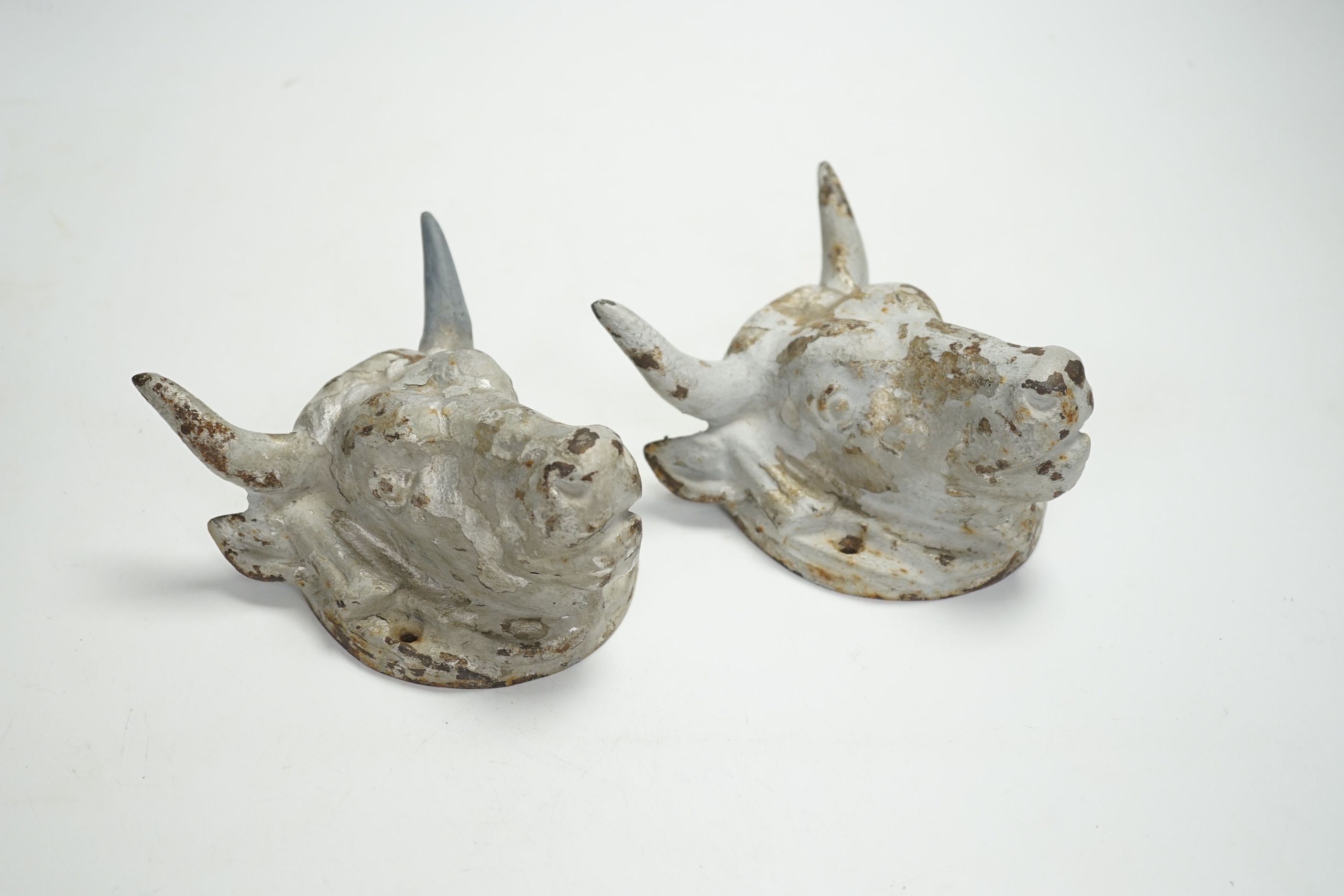 A pair of cast iron ‘bulls head’ mounts, 13.5cm